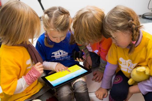 Children play with Microsoft's "Schlaumaeuse" education software that runs on a Windows 8 operated tablet computer during the program's presentation in Berlin