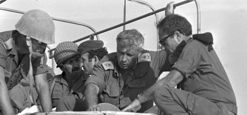 Then-Israeli Major General in the Reserves Ariel Sharon (2nd R) confers with comrades during the 1973 Middle East War in the Sinai Peninsula, October 10, 1973 in this handout photo released by the Government Press Office. Sharon, a dominant figure for decades in shaping the Middle East, was fighting for his life on January 5, 2006, after suffering a massive brain haemorrhage. ISRAEL OUT BW ONLY REUTERS/Shlomo Arad/Government Press Office/Handout - RP3DSFDYCZAB