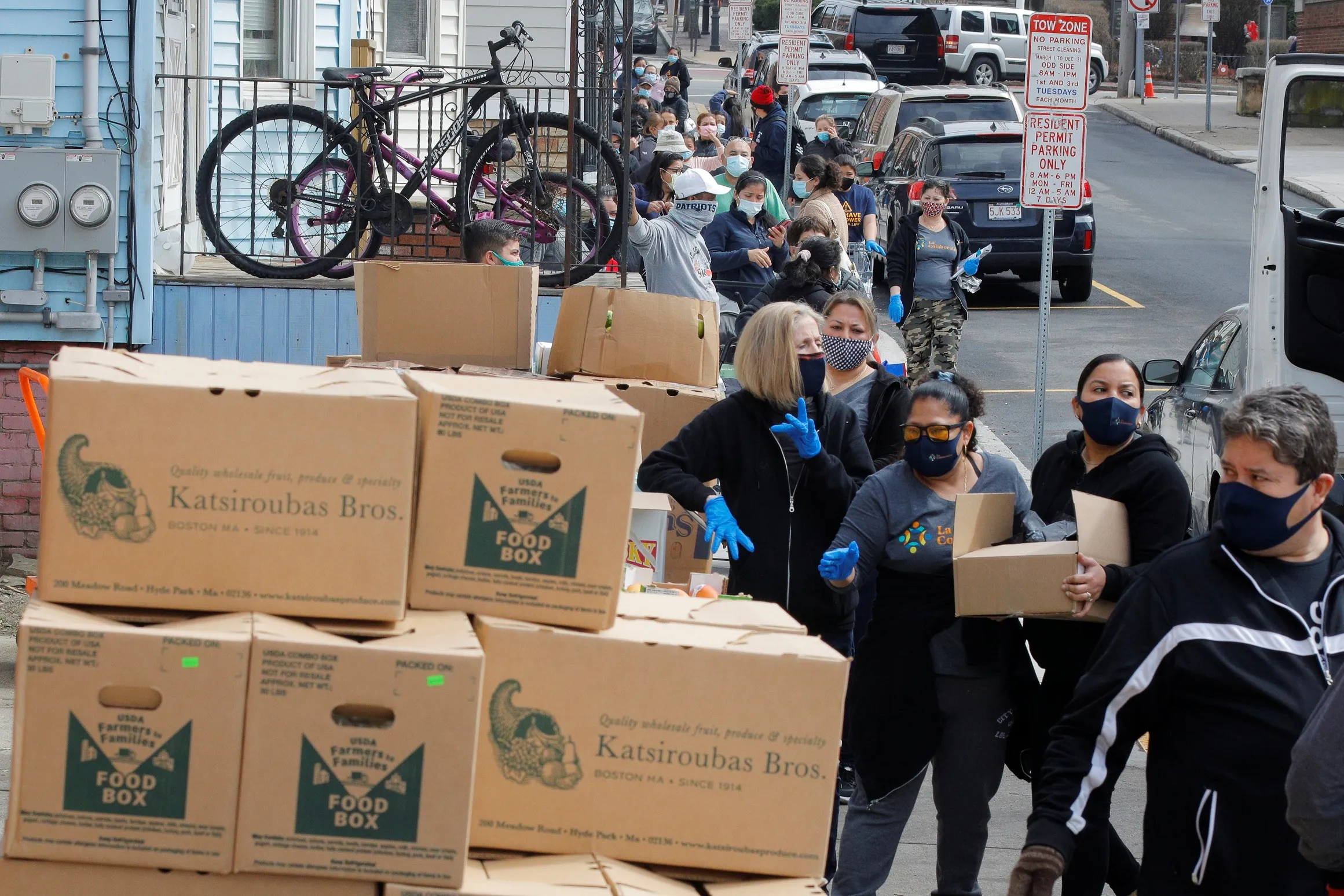 Residents wait in line to pick up free groceries at the food pantry at La Colaborativa amid the coronavirus disease (COVID-19) pandemic in hard hit in Chelsea, Massachusetts, U.S., March 25, 2021. REUTERS/Brian Snyder