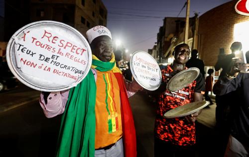 Ibrahima Soumare, 47, a supporter of Senegal's main opposition coalition Yewwi Askan Wi holds signs glued on pot lids during a protest over the disqualification of their national list for the July 31 legislative election in Dakar, Senegal, June 22, 2022. REUTERS/Zohra Bensemra