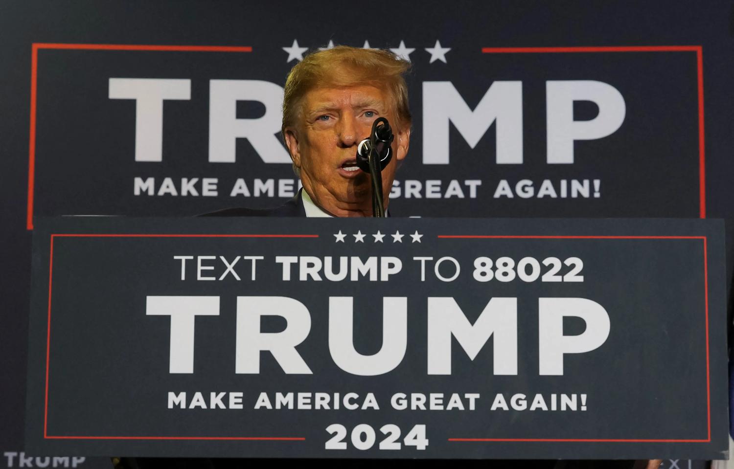U.S. Presidential Candidate Donald Trump speaking at a 2024 Trump Campaign Podium