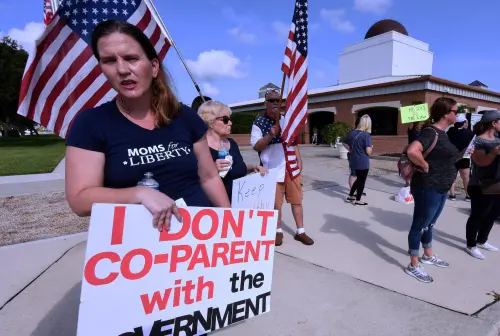 A member of Moms for Liberty protests against mandatory face masks for students during the COVID-19 pandemic at a meeting of the Brevard County School Board in Viera. The Southern Poverty Law Center (SPLC) is for the first time labeling Florida-headquartered Moms for Liberty and 11 other right-wing "parents' rights" groups as anti-government extremist groups in its annual report, released on June 6, 2023. (Photo by Paul Hennessy / SOPA Images/Sipa USA.)