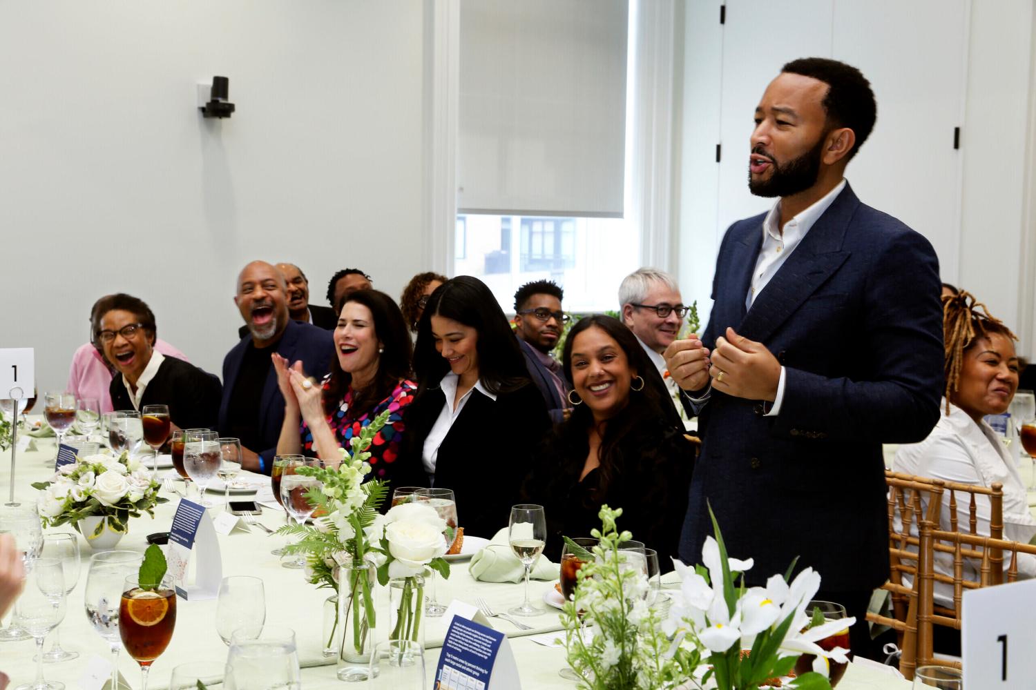 John Legend speaking at lunch table