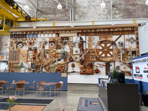 Northland Workforce Training Center lobby. Mural with wooden gears representing an artistic blend of manufacturing and technology