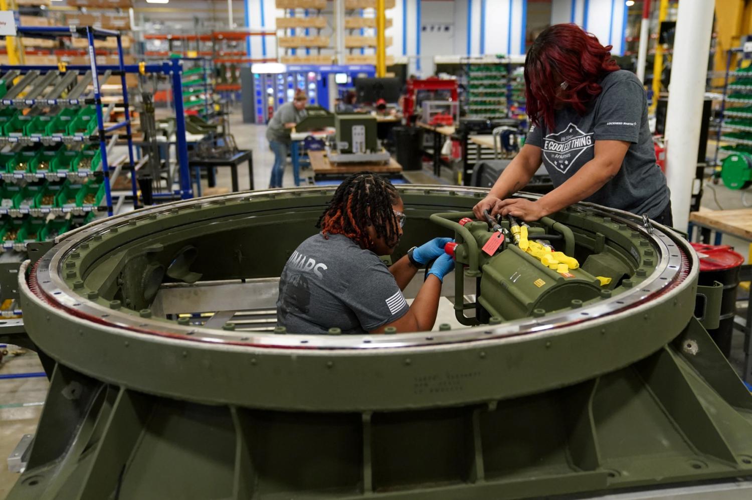 Technicians work on a M270 missile launcher base at Lockheed Martin Camden Operations in Camden, Arkansas, U.S., February 27, 2023.