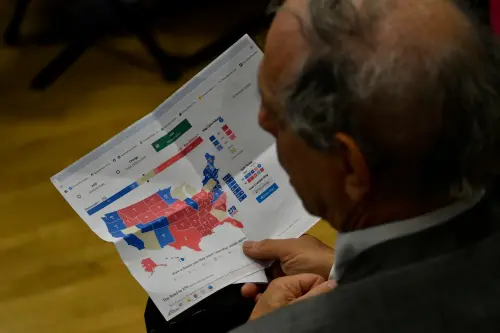 A man in the audience holds a printed page showing a map with electoral vote data of the U.S. Congressional elections at a campaign event with U.S. President Joseph Biden in North Philadelphia, PA, USA on April 18, 2024.