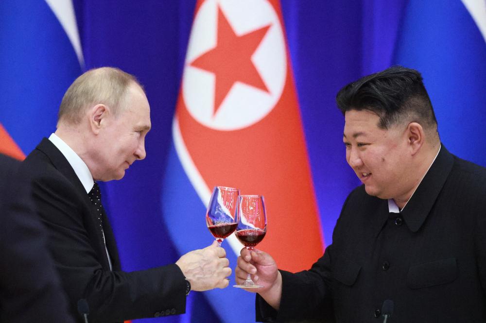 Russian President Vladimir Putin and North Korean leader Kim Jong Un attend a state reception in Pyongyang, North Korea, June 19, 2024. Sputnik/Vladimir Smirnov/Pool via REUTERS