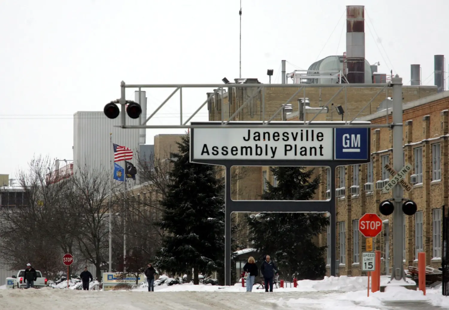 Workers leave the GM plant in Janesville, Wisconsin, after the last vehicle, a black Chevy Tahoe, rolled off the assembly line December 23, 2008 after manufacturing trucks, automobiles, SUVs, and tractors since 1919.
