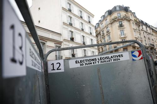 Signs showing the dates of the French parliamentary elections, posted to a metal facade
