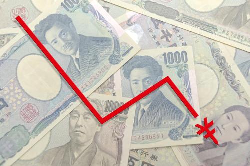 A red, downward-trending line representing depreciation appears over an image of Japanese yen