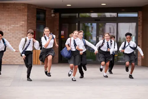 A group of private school students exit their school.