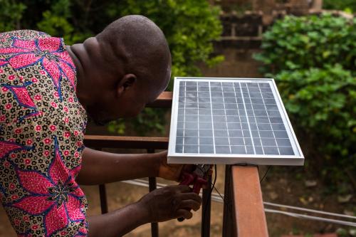 Tunde, an engineer, installs a 30W solar panel for power generation in Ibadan, Oyo on June 6, 2023.
