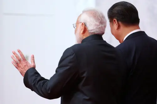 Indian Prime Minister Narendra Modi (L) gestures as he talks with Chinese President Xi Jinping (R) as they arrive for a group photo during the BRICS Summit at the Xiamen International Conference and Exhibition Center in Xiamen, southeastern China's Fujian Province, China September 4, 2017.