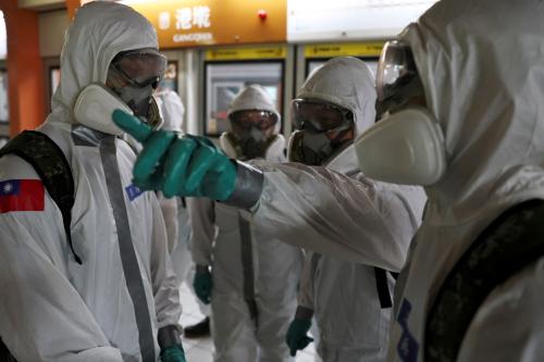 Soldiers wear protective suits during disinfection at a metro station following a surge of coronavirus disease (COVID-19) infections in Taipei, Taiwan May 19, 2021.