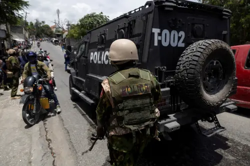 A Kenyan Police officer stands guard on the site where one of the armoured vehicles used by the Kenyan police and Haitian National police SWAT units to patrol broke down on a steep hill while patrolling through a neighborhood, after the arrival of the first contingent of Kenyan police as part of a peacekeeping mission, in Port-au-Prince, Haiti June 28, 2024.