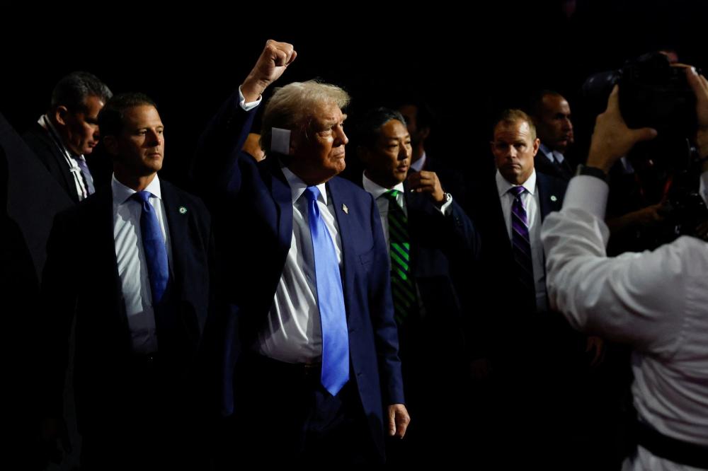 Republican presidential nominee and former U.S. President Donald Trump raises is fist as he leaves at the conclusion of Day 2 of the Republican National Convention (RNC), at the Fiserv Forum in Milwaukee, Wisconsin, U.S., July 16, 2024.