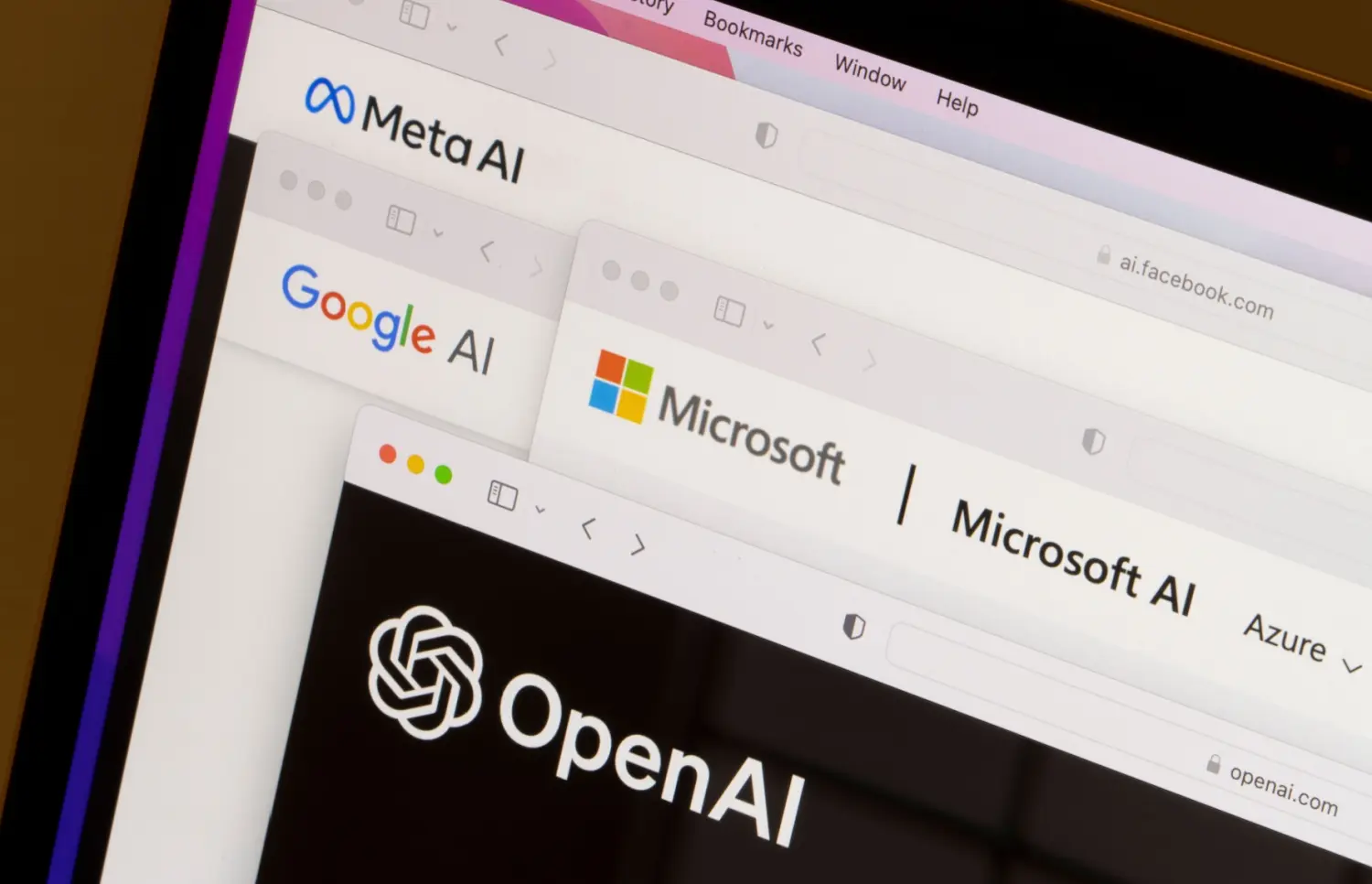 Webpages of OpenAI, Microsoft AI, Google AI, and Meta AI are seen on a laptop computer.