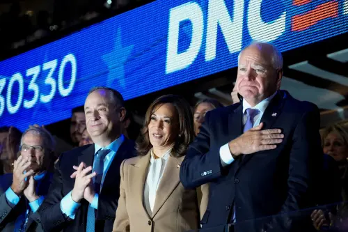 Democratic presidential candidate and U.S. Vice President Kamala Harris, her husband Doug and U.S. Democratic vice presidential candidate Minnesota Governor Tim Walz look on during Day 1 of the Democratic National Convention (DNC) at the United Center, in Chicago, Illinois, U.S., August 19, 2024. REUTERS/Cheney Orr