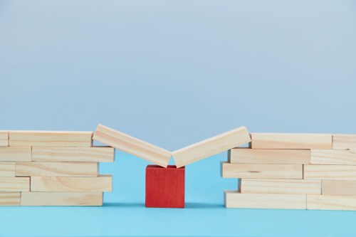 A bridge resting on a red cube represents the safety net