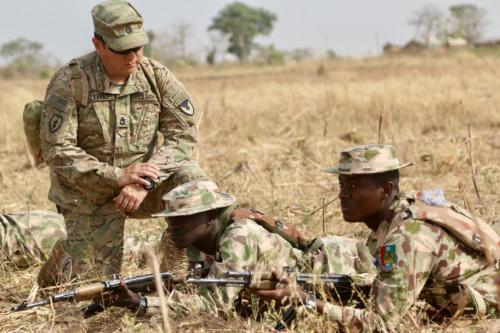 A U.S. Army soldier (L) trains Nigerian Army soldiers at a military compound in Jaji, Nigeria, February 13, 2018.