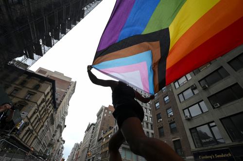 A person holds a rainbow flag as they participate in New York City Pride March along 5th Avenue, New York, NY, June 30, 2024.