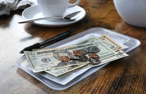 Cash on top of a receipt at a cafe