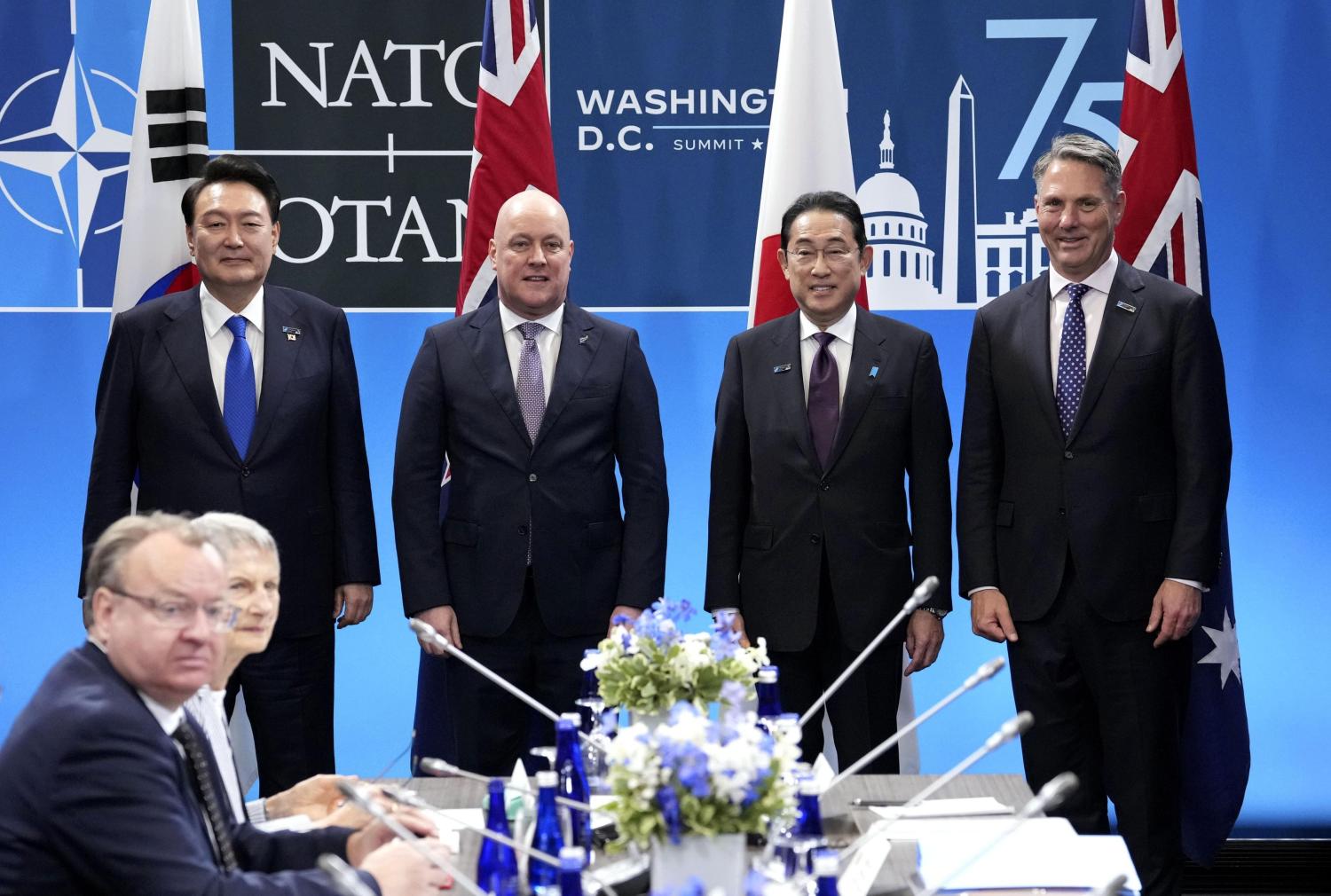 (From L) South Korea's President Yoon Suk Yeol, New Zealand's Prime Minister Cristopher Luxon, Japan's Prime Minister Fumio Kishida and Australia's Deputy Prime Minister Richard Marles pose for photos before a meeting of NATO's four Indo-Pacific partners, known as IP4, in Washington on the final day of a NATO meeting on July 11, 2024.