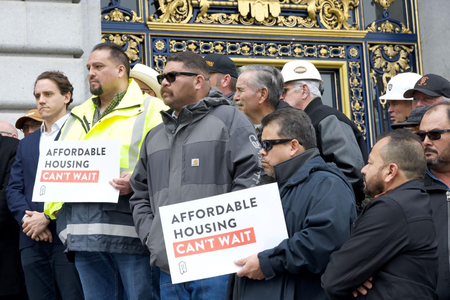 Union workers line the steps of City Hall holding signs listening to Mayor London Breed speaking at an Affordable Housing Press Conf - San Francisco, CA - March 01, 2024. Credit: Sheila Fitzgerald/Shutterstock