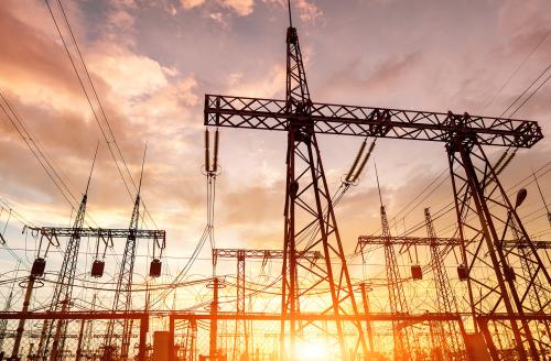 distribution electric substation with power lines silhouette on the dramatic sunset background.