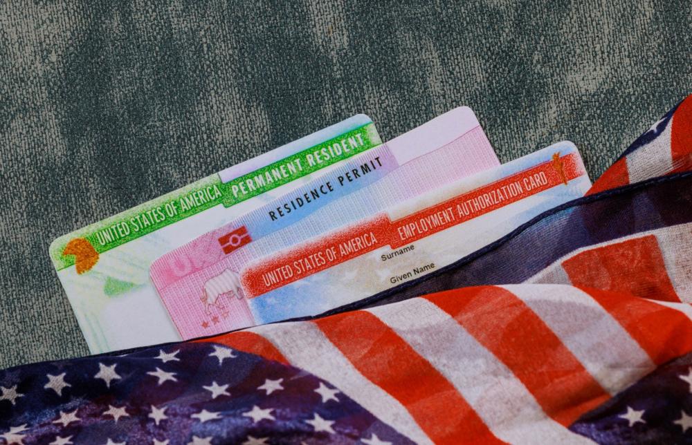 US Permanent Resident card, Residence Permit, and Employment Authorization Card with American flag