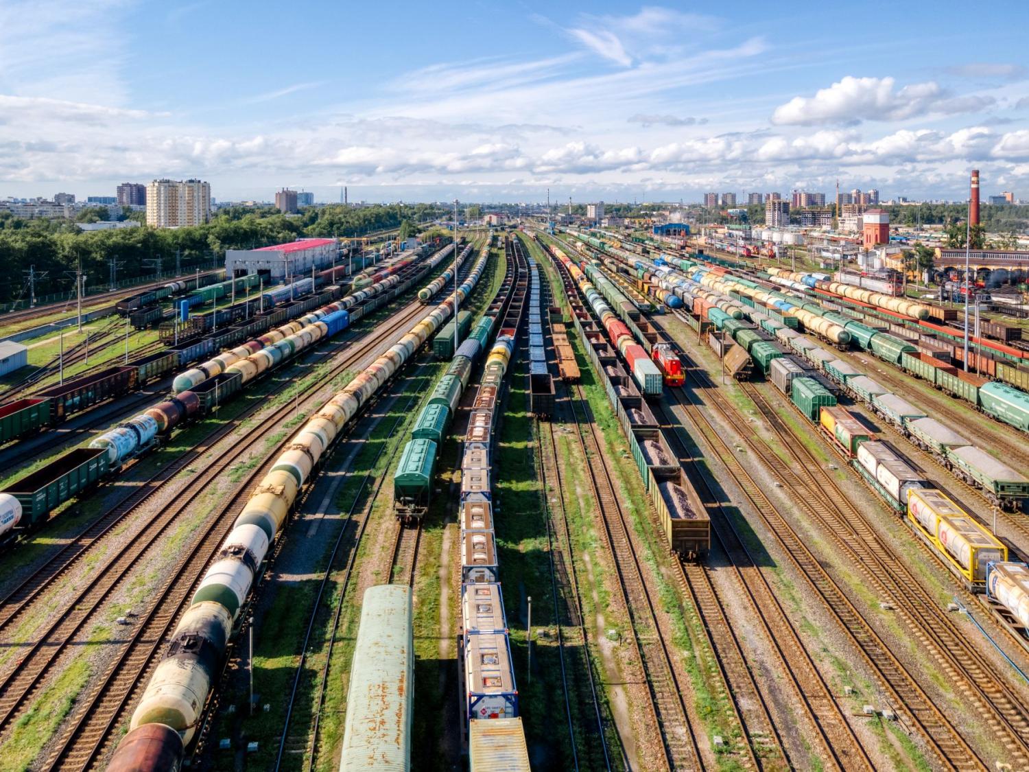 A railyard populated with numerous cargo trains